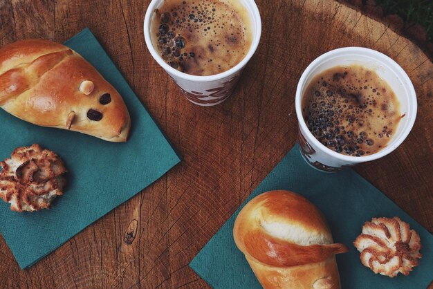 High angle view of coffee with food served on table