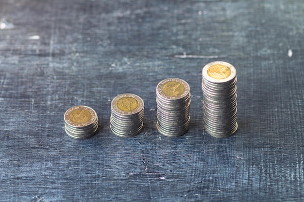 high angle view of coins stacks on wooden table