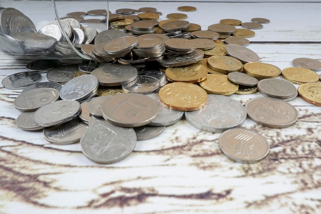 High angle view of coins on wooden table