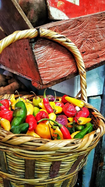 High angle view of color chili peppers in wicker basket