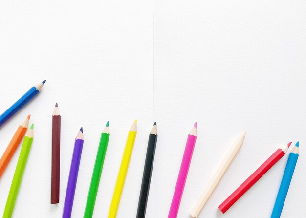 Photo high angle view of colored pencils against white background