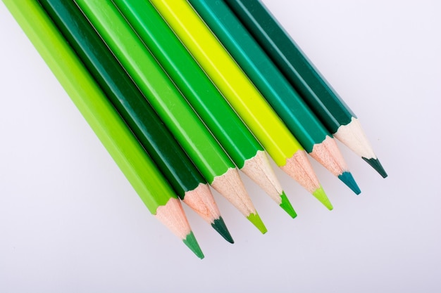 High angle view of colored pencils against white background