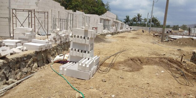 High angle view of construction site by buildings against sky