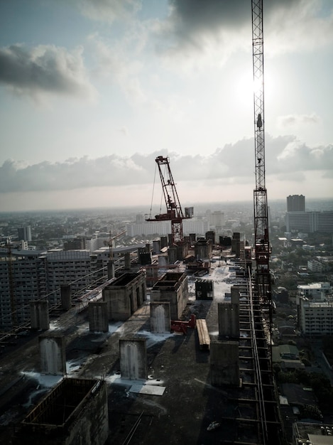 High angle view of crane and buildings against sky