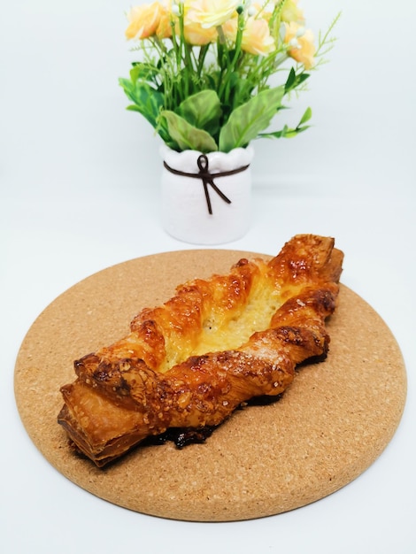 High angle view of croissant on cutting board against flowers