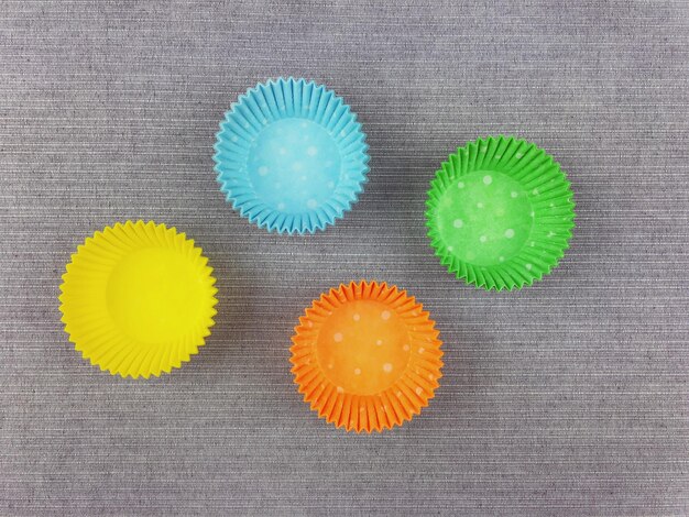 High angle view of cupcake holders on table