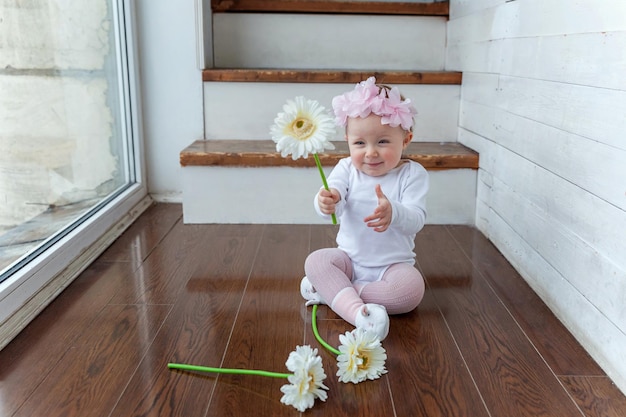 High angle view of cute baby girl sitting on floor