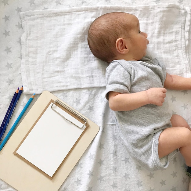 High angle view of cute baby lying on bed