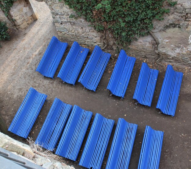 High angle view of deck chairs against blue wall