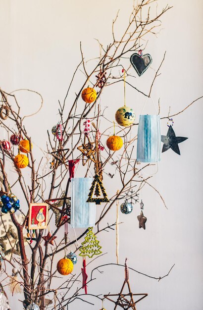 Photo high angle view of decorations and face masks hanging on tree