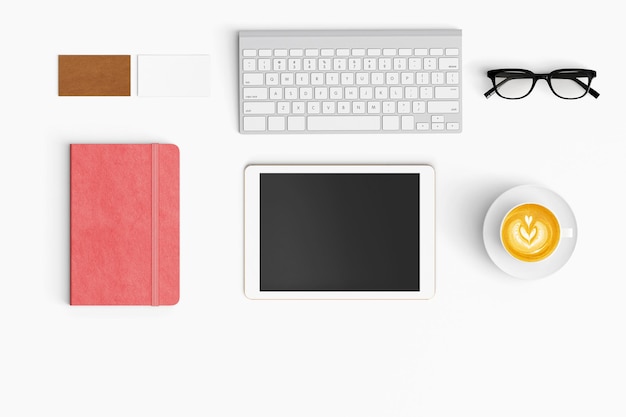 High angle view of digital tablet with coffee and note pad on white background