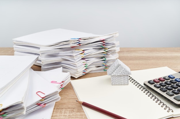 High angle view of documents and calculator on table at office