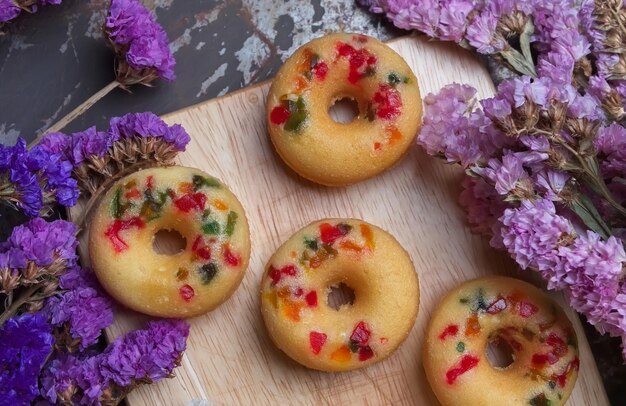 High angle view of donuts with flowers on cutting board