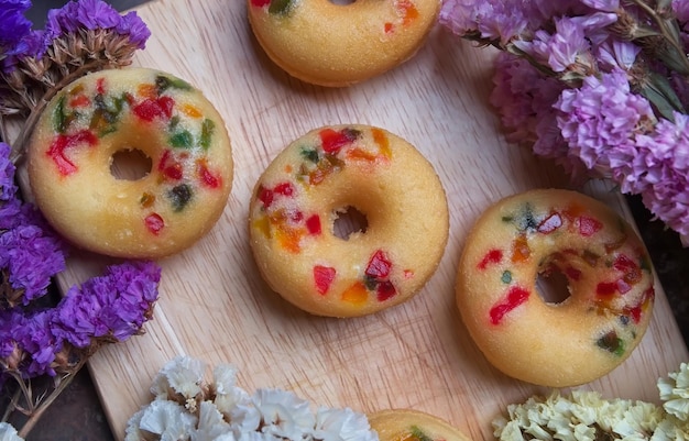 High angle view of donuts with flowers on cutting board