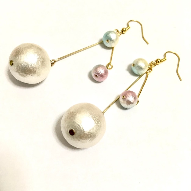 High angle view of earrings over white background