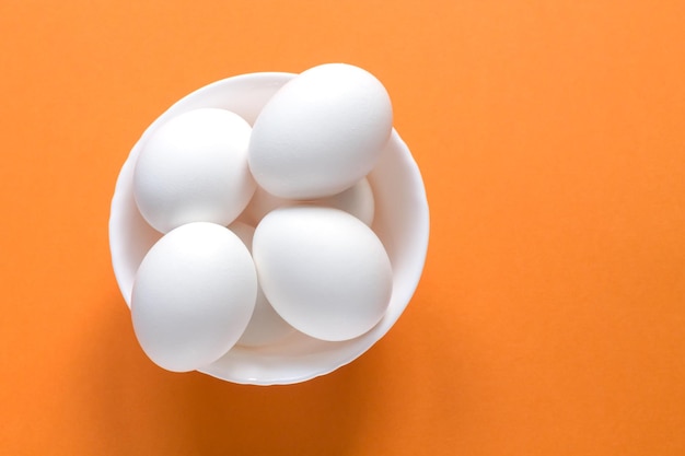 High angle view of eggs against orange background