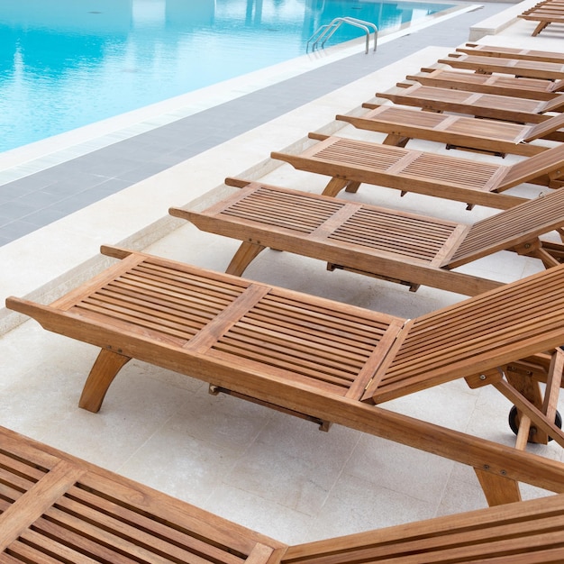 High angle view of empty chairs by swimming pool