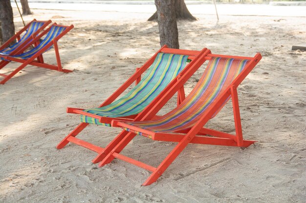 High angle view of empty chairs and table on beach