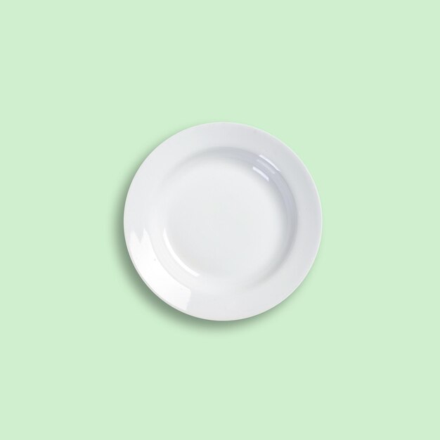 High angle view of empty plate on green background