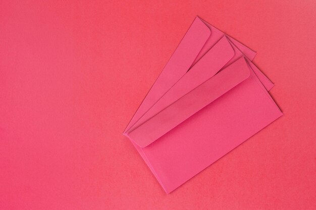 High angle view of envelopes on red background