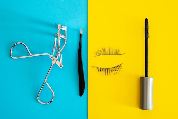 High angle view of eye make-up equipment on colored background