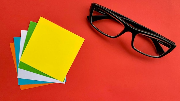 High angle view of eyeglasses on red background