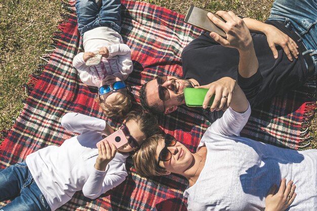 Photo high angle view of family taking selfie at park