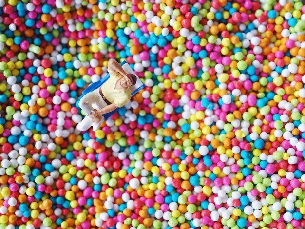 High angle view of figurine on multi colored balls