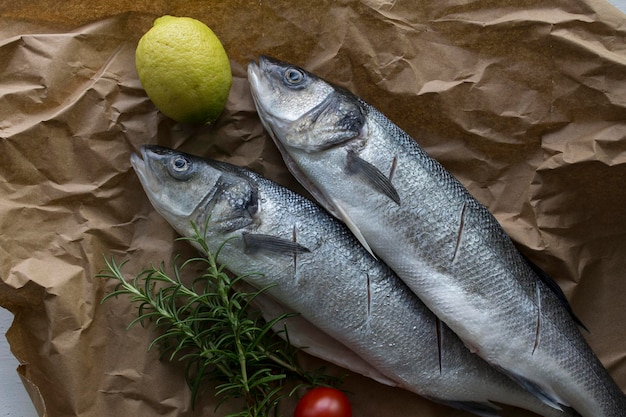 High angle view of fish with ingredients on brown paper