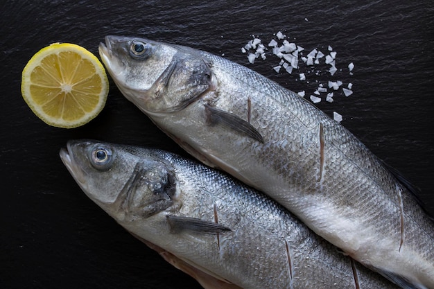 high angle view of fish with ingredients on slate