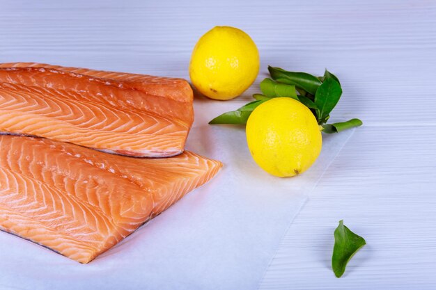 High angle view of fish with lemons and herbs on table