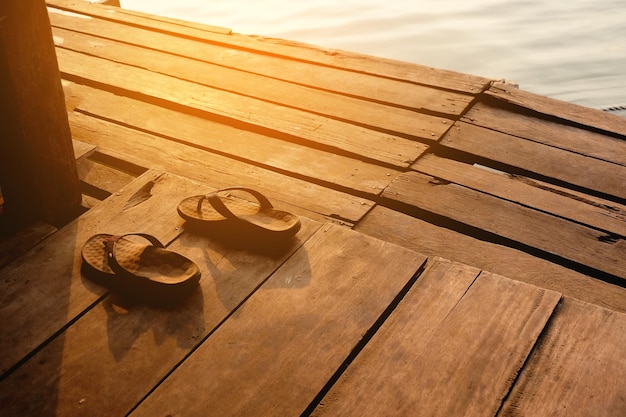 High angle view of flip-flops on pier over lake