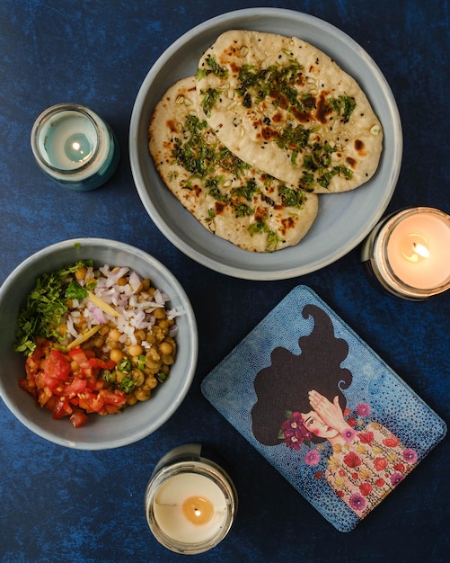 High angle view of food naan kulcha bread and spicy peas mattar on table