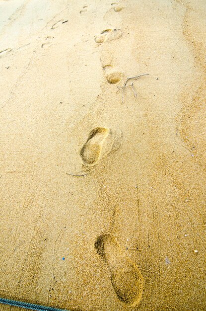 High angle view of footprints on sand at beach