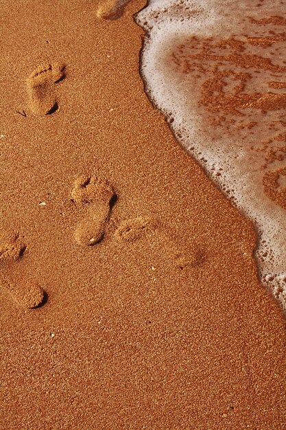 High angle view of footprints on sand at beach