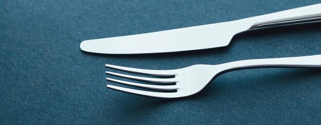High angle view of fork on blue background