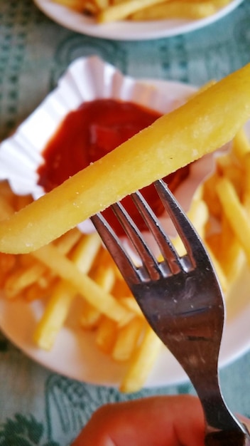 High angle view of fork and fries