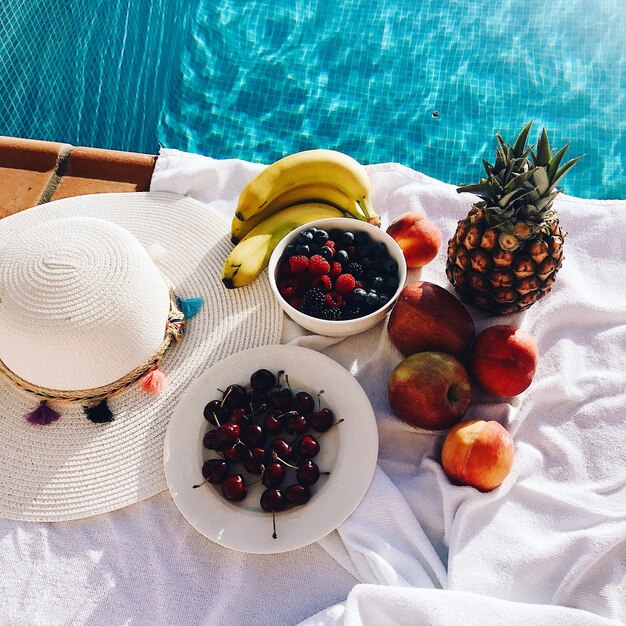 High angle view of fruits on table at swimming pool