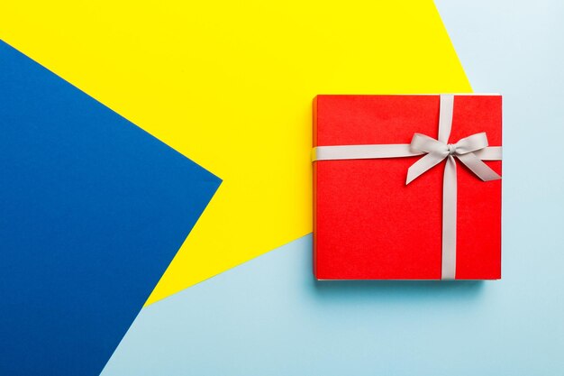 High angle view of gift box on colored background