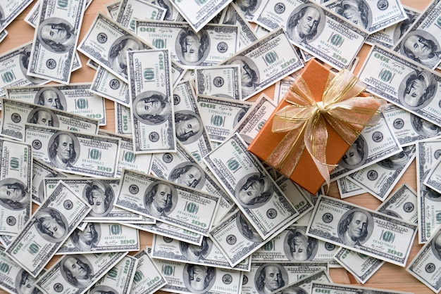 High angle view of gift box with paper currencies on table