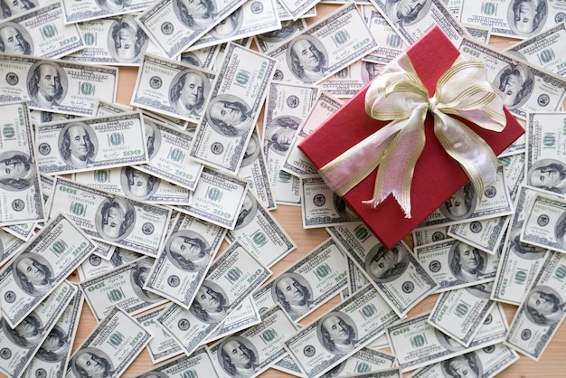 High angle view of gift box with paper currencies on table