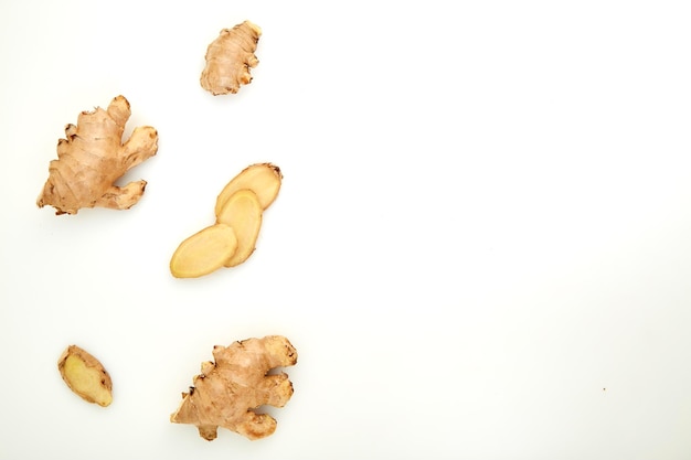 High angle view of ginger slices over white background