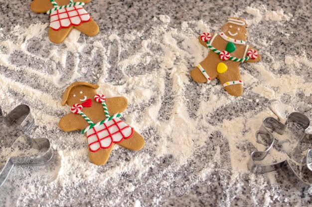 High angle view of gingerbread men on flour