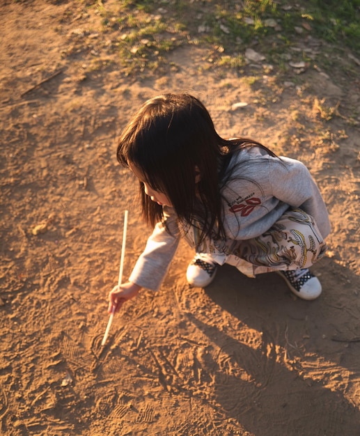 Photo high angle view of girl playing on sand