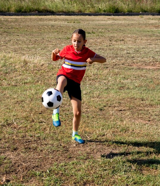 High angle view of girl playing soccer on land