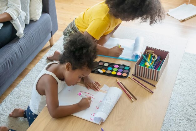 High angle view of girls drawing on table