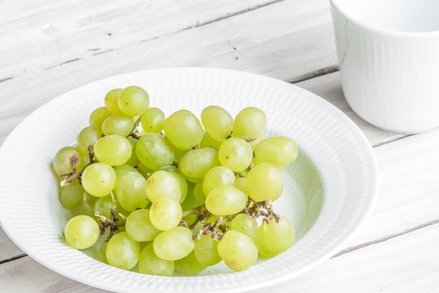 High angle view of grapes in bowl on table