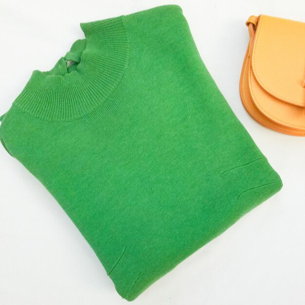 High angle view of green clothing on white background