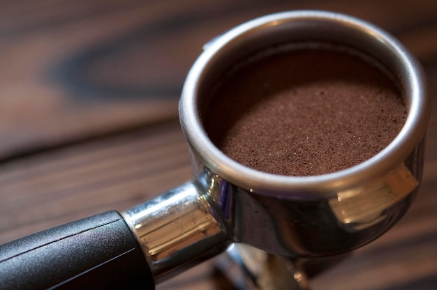 high angle view of ground coffee in container on table at cafe