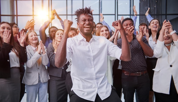 High angle view of group of happy multiethnic people raising hands together